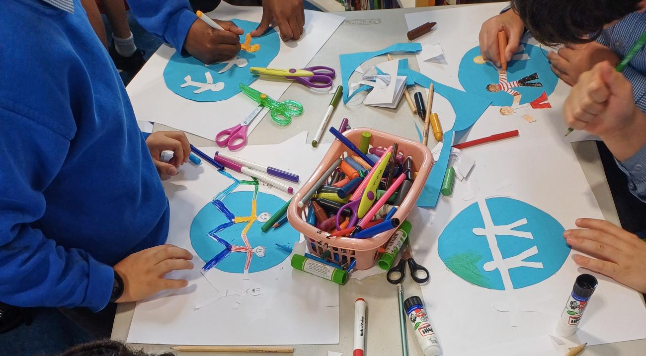 Children painting and drawing in a library